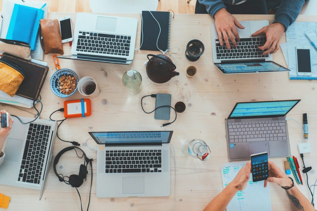 Equipe comparando sistema personalizado e CRM pronto em reunião
